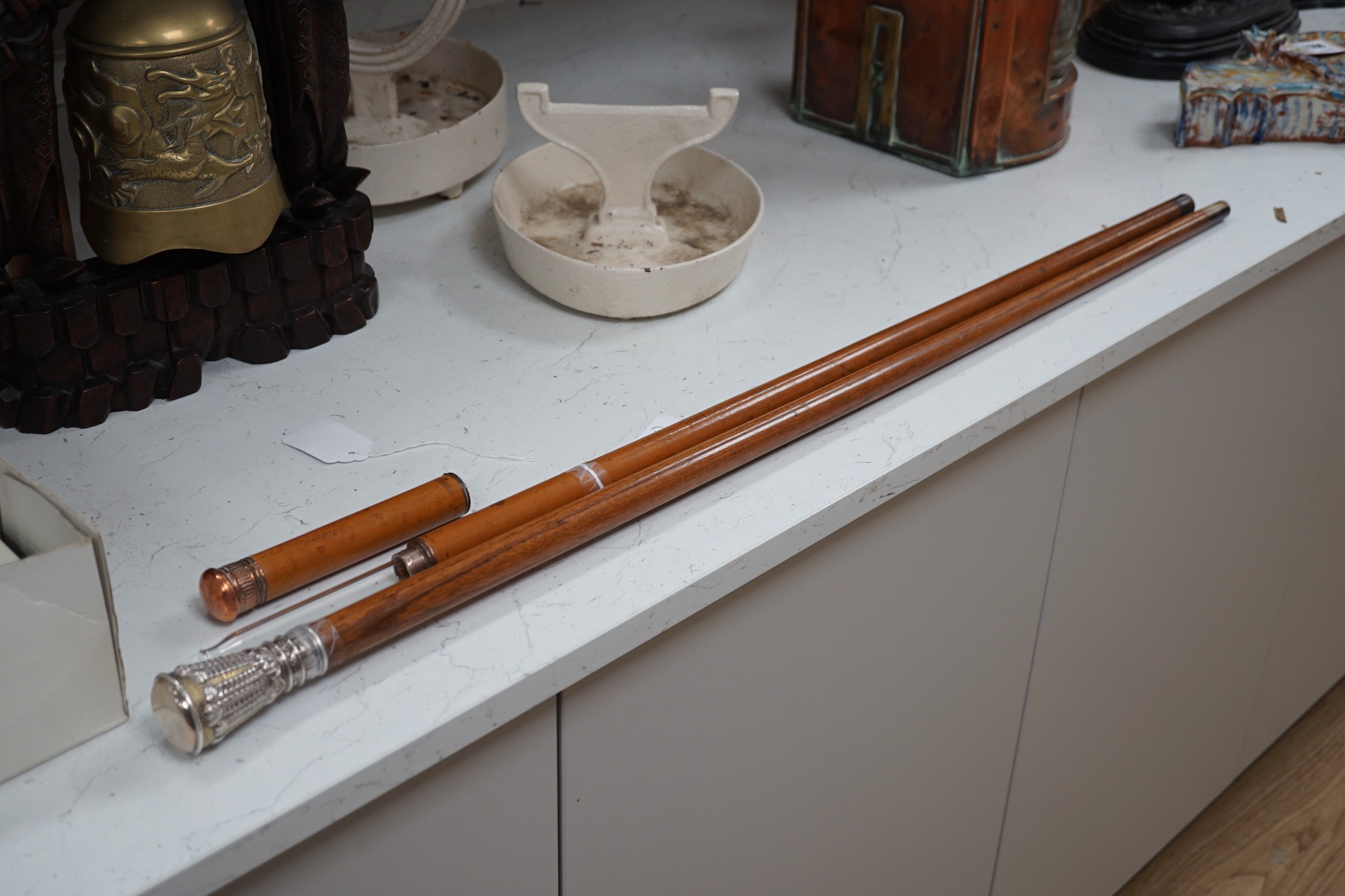 A silver handled cane win a horn tip and a copper handled flask cane, silver handled cane 94 cms long